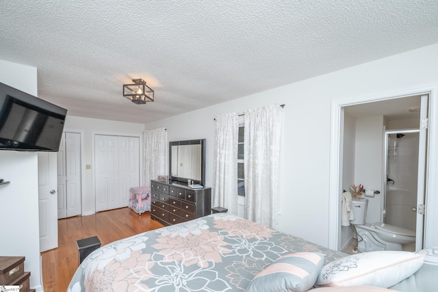 bedroom featuring light wood-type flooring and a textured ceiling