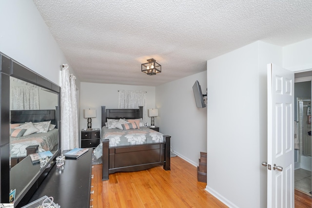 bedroom featuring a textured ceiling and wood-type flooring