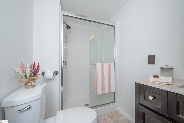 bathroom featuring toilet, vanity, tile patterned flooring, and an enclosed shower