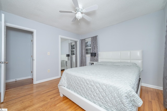 bedroom featuring a textured ceiling, a closet, hardwood / wood-style floors, and ceiling fan