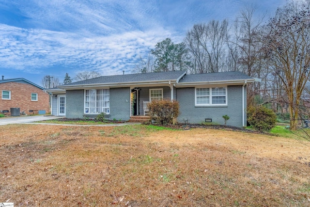 ranch-style house featuring central AC unit and a front yard