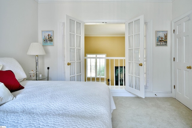 carpeted bedroom with french doors and ornamental molding