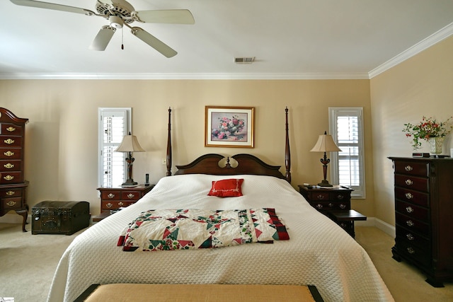 carpeted bedroom with crown molding and ceiling fan