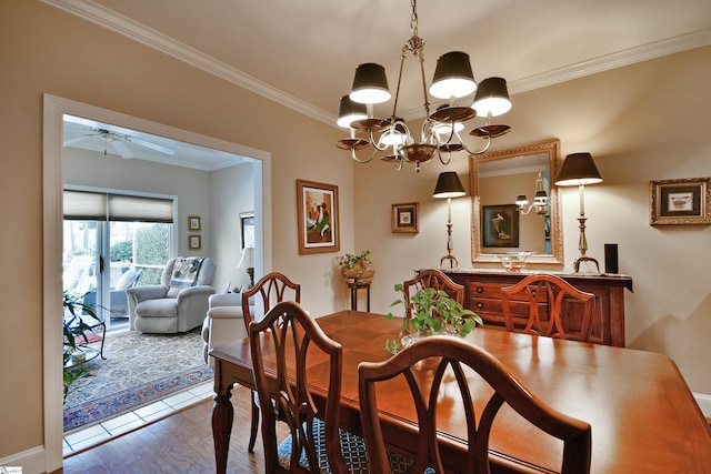 dining area featuring ceiling fan with notable chandelier, crown molding, and wood-type flooring