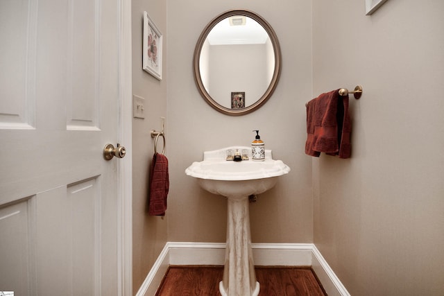 bathroom with hardwood / wood-style flooring