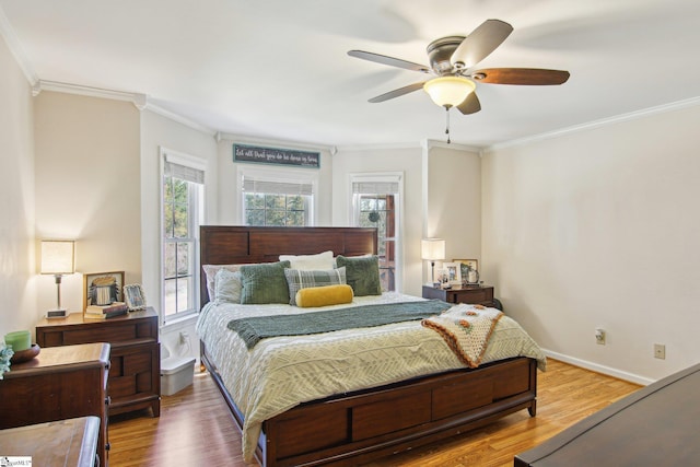 bedroom with ceiling fan, crown molding, and wood-type flooring