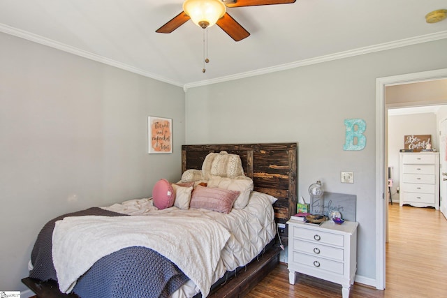 bedroom with hardwood / wood-style flooring, ceiling fan, and crown molding