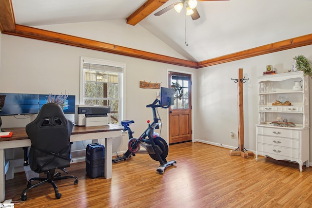 office space featuring ceiling fan, light hardwood / wood-style flooring, and vaulted ceiling with beams