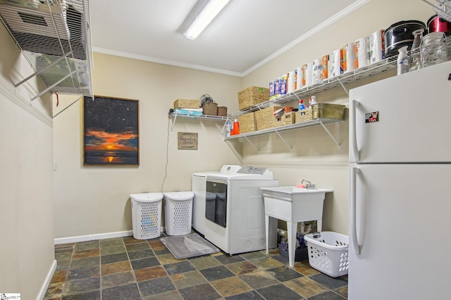 washroom with ornamental molding and separate washer and dryer