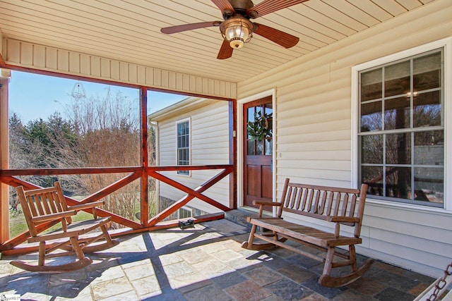 sunroom featuring ceiling fan and wooden ceiling