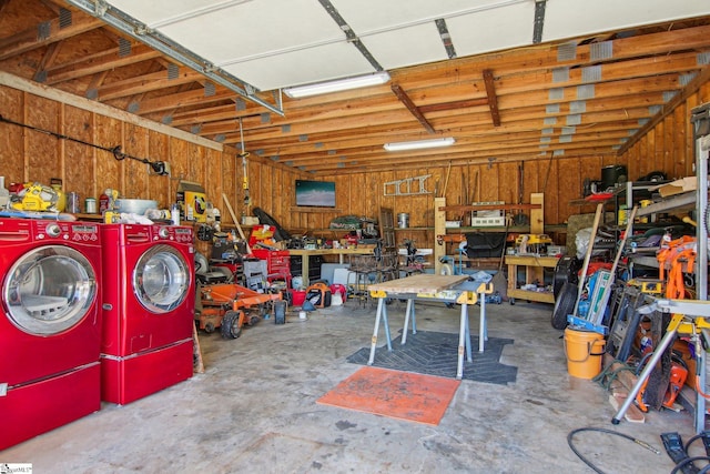 garage with a workshop area and washing machine and dryer