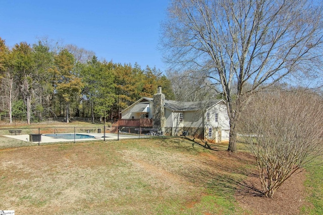 view of yard with a swimming pool side deck