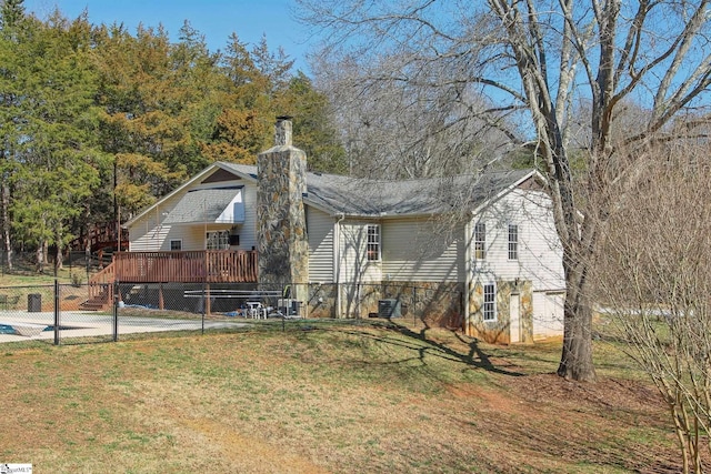 exterior space with a deck, a front lawn, and cooling unit