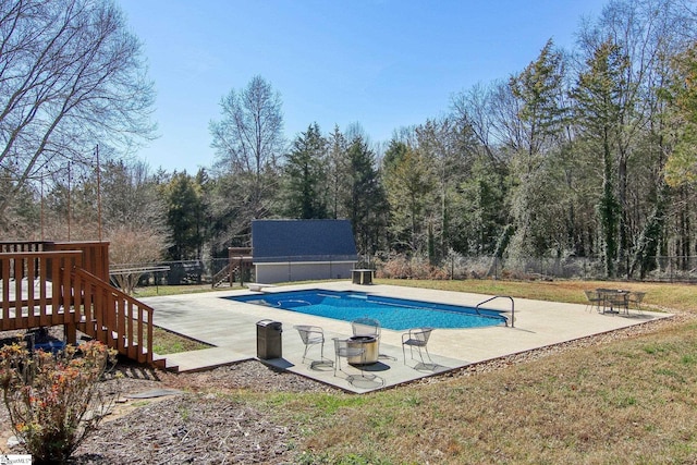 view of pool featuring a patio area and a diving board