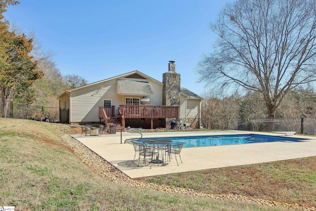 view of pool featuring a yard, a wooden deck, and a patio area