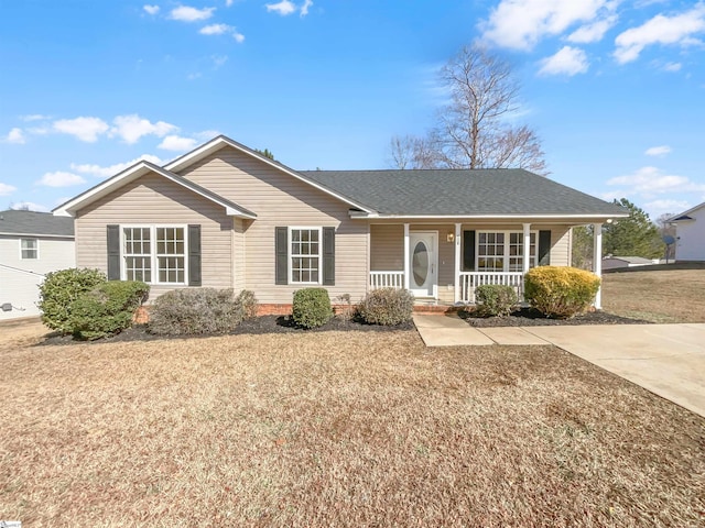 ranch-style house with covered porch and a front yard