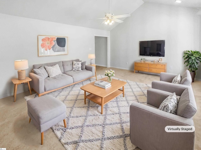 living room with ceiling fan, vaulted ceiling, and carpet