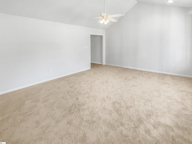 empty room featuring high vaulted ceiling, light colored carpet, and ceiling fan