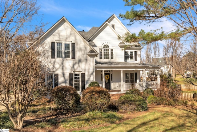 view of front of home featuring covered porch and a front yard