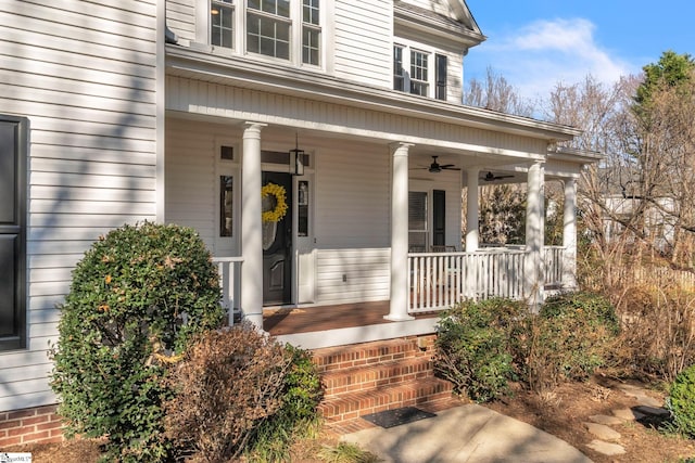 doorway to property with ceiling fan and a porch