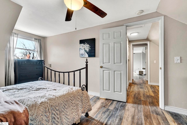 bedroom with dark hardwood / wood-style flooring, ceiling fan, and lofted ceiling