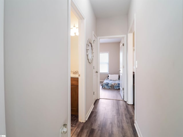 corridor with dark hardwood / wood-style flooring