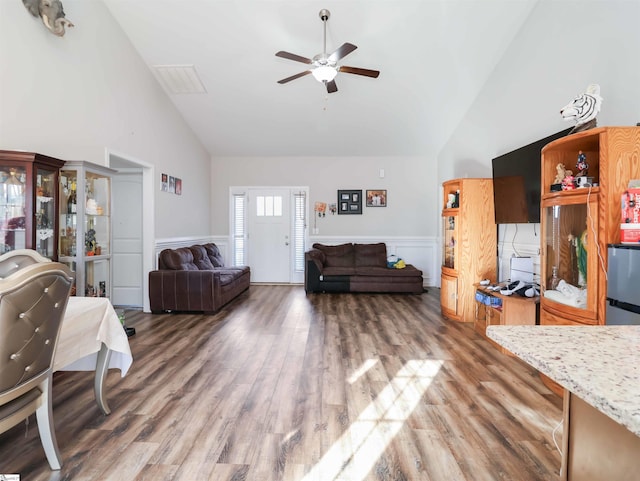 living room with ceiling fan, high vaulted ceiling, and dark hardwood / wood-style flooring