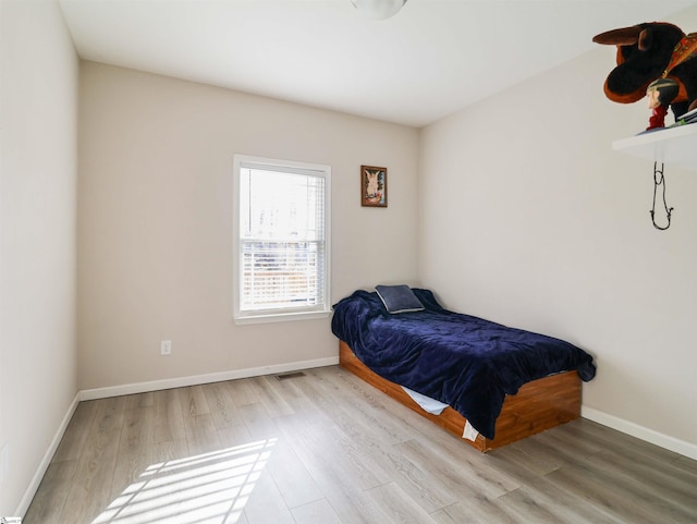 bedroom with light wood-type flooring