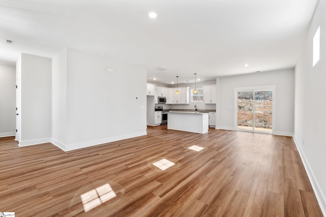 unfurnished living room with light hardwood / wood-style floors