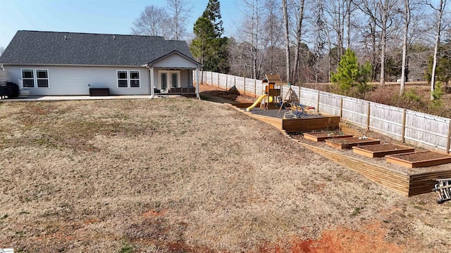 rear view of house with a playground and a patio