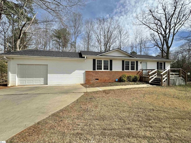 ranch-style house with a garage and a front lawn