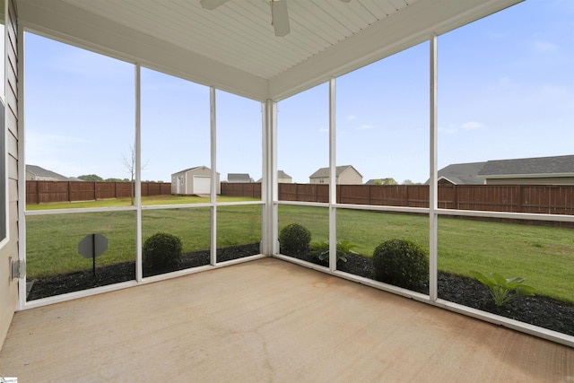 unfurnished sunroom featuring ceiling fan