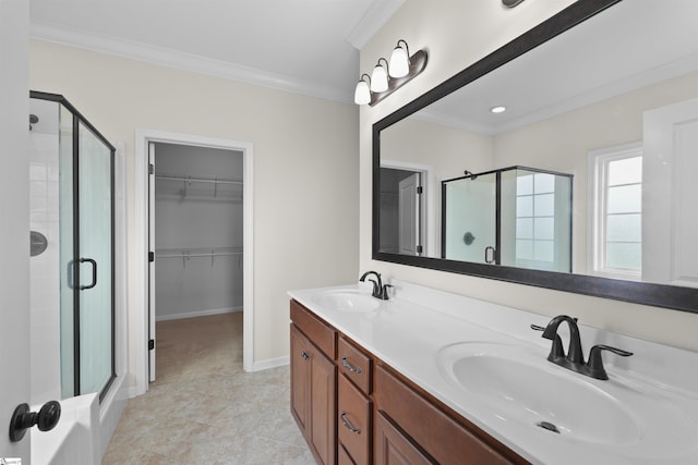 bathroom with vanity, crown molding, and a shower with shower door