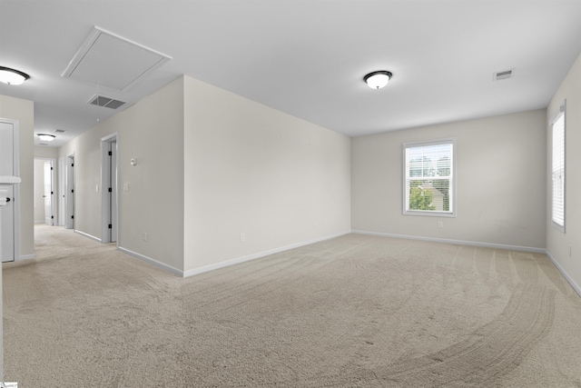 unfurnished room featuring light colored carpet