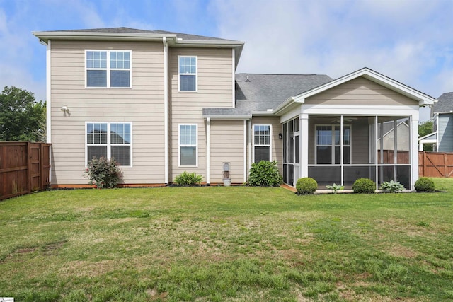 rear view of property featuring a lawn and a sunroom