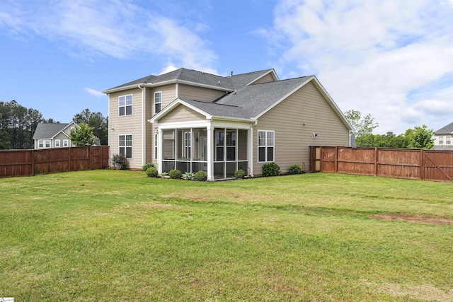 rear view of property with a sunroom and a lawn