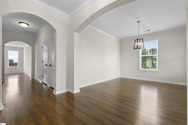 unfurnished room featuring ornamental molding, dark wood-type flooring, and a healthy amount of sunlight