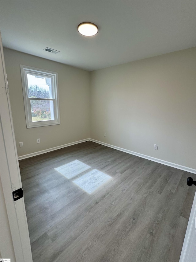 spare room with hardwood / wood-style floors