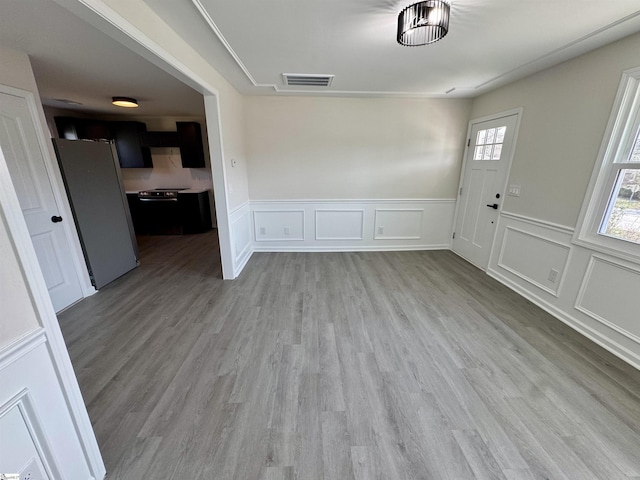 unfurnished dining area featuring light hardwood / wood-style flooring