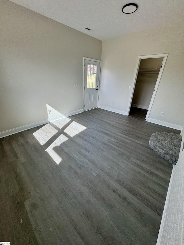 spare room with dark wood-type flooring