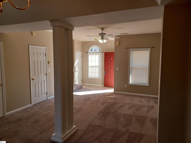 foyer with carpet, decorative columns, and ceiling fan