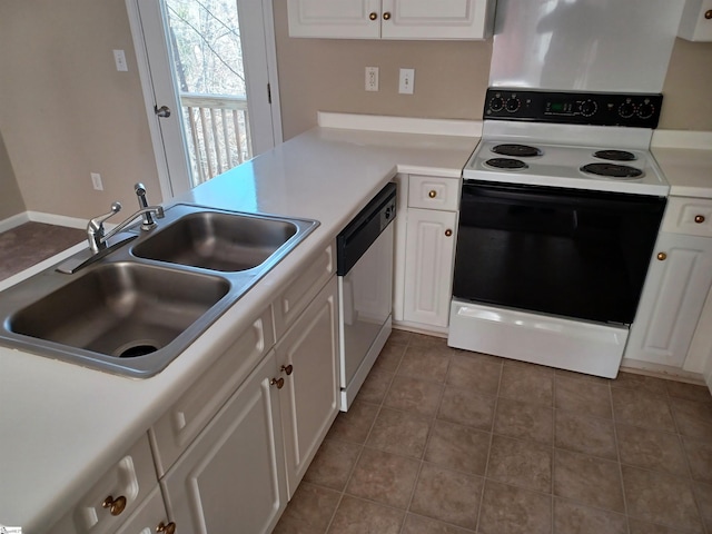 kitchen with sink, range with electric cooktop, dark tile patterned flooring, stainless steel dishwasher, and white cabinets