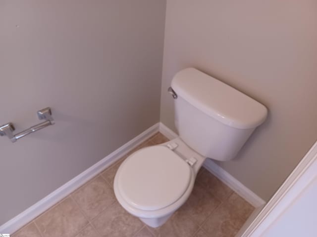 bathroom featuring tile patterned flooring and toilet