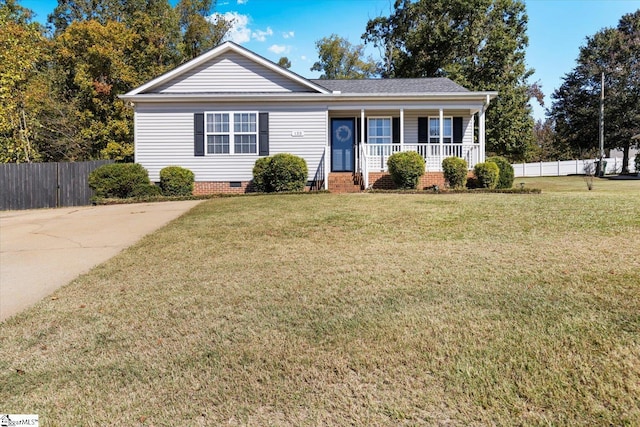 single story home featuring covered porch and a front yard