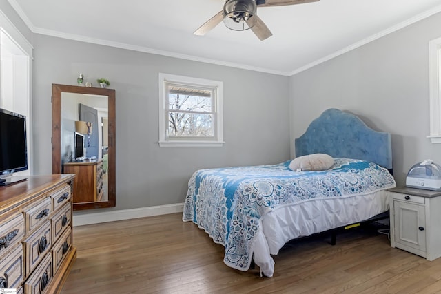 bedroom with ornamental molding, ceiling fan, and wood-type flooring