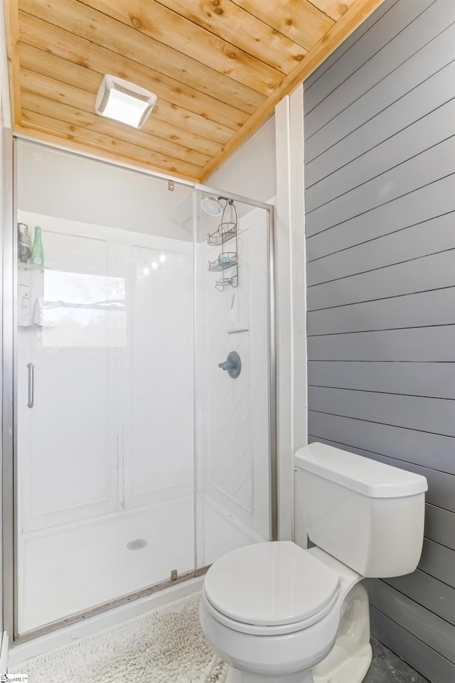 bathroom with wooden walls, wood ceiling, toilet, and an enclosed shower