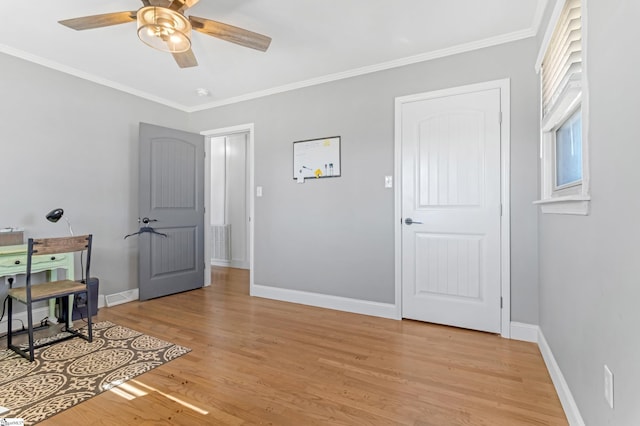 home office featuring light wood-type flooring, crown molding, and ceiling fan