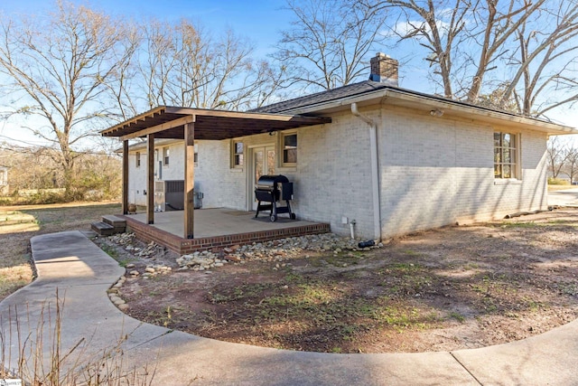 view of side of home featuring a patio