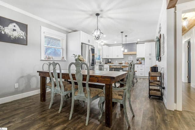 dining space with dark hardwood / wood-style flooring, ornamental molding, and a chandelier