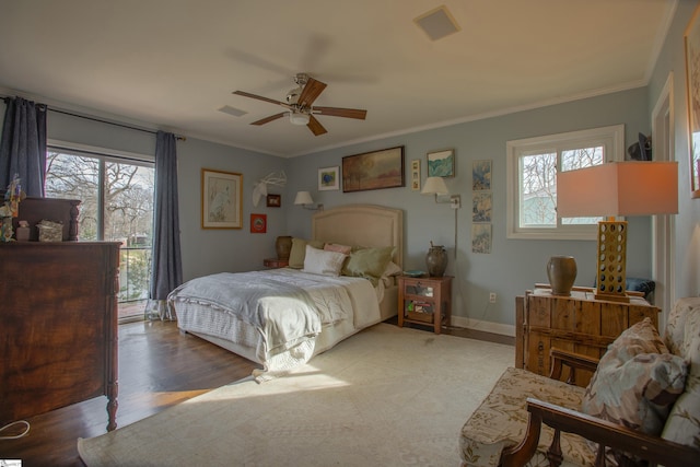 bedroom featuring hardwood / wood-style flooring, ornamental molding, and ceiling fan